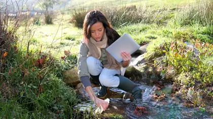 Woman testing river water.