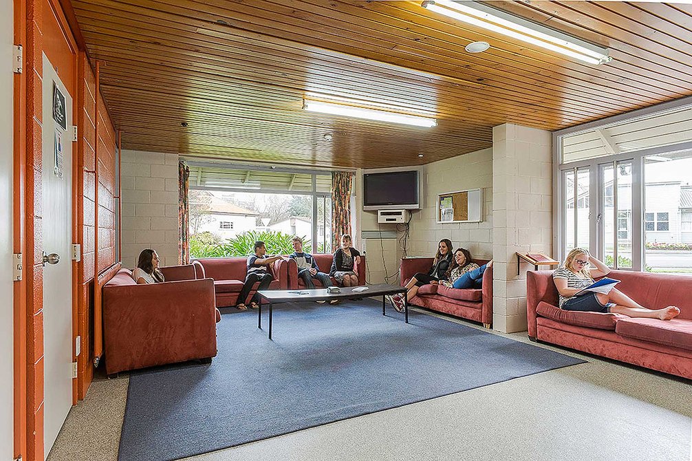 Interior of the Kairanga and Rotary Courts common room with students sitting and lying on couches