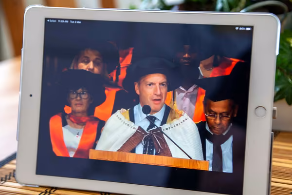 Close-up of a tablet screening graduation livestream