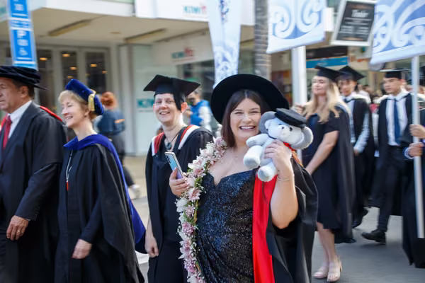 Graduate smiling during procession