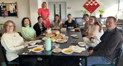Massey staff gathered around a table during a Green Impact shared lunch