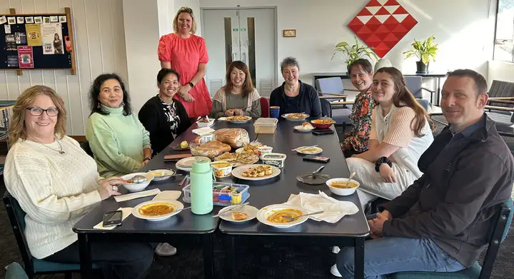 Massey staff gathered around a table during a Green Impact shared lunch