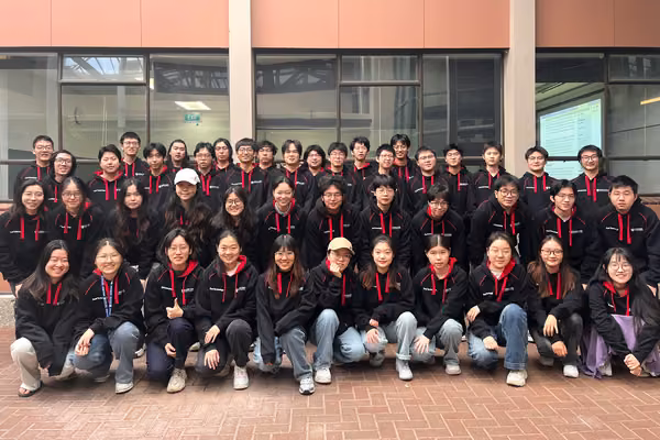 Group of food technology students all wearing matching black hoodies