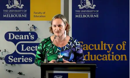 Professor Jodie Hunter presenting at a podium at the University of Melbourne