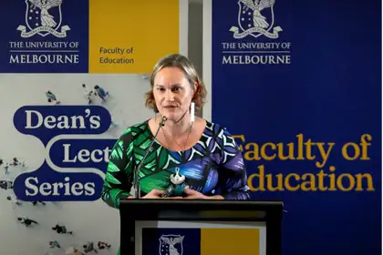 Professor Jodie Hunter presenting at a podium at the University of Melbourne