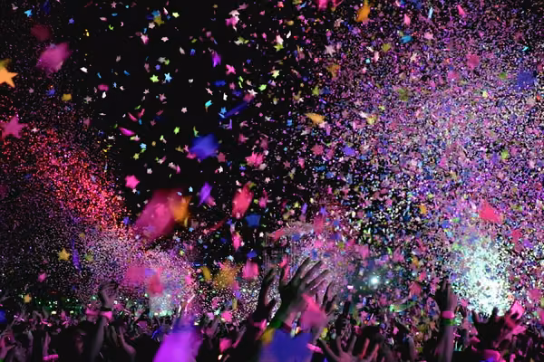 Star shaped confetti at an outdoor concert at night.