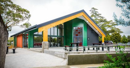 Exterior of a marae, with large areas of concrete paving and fixed seating in the foreground