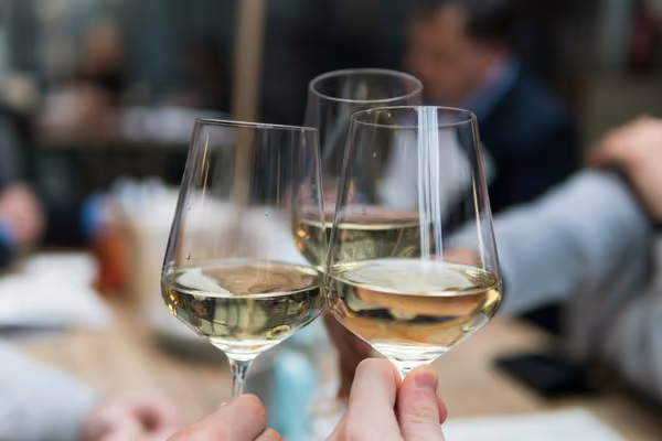 three half full wine glasses held together