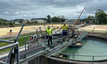 Caitlyn Poole and Graeme Jacobson on top of the clarifiers at Fonterra