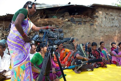 Two women farmers of the community media centre recording a focus group discussion about a CARE campaign.