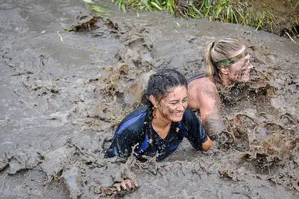Participants in the Auckland event, wading through a mud pit