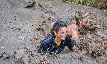Participants in the Auckland event, wading through a mud pit