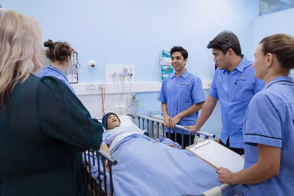 nursing students interact with training dummy