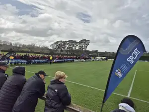 supporters on the sideline cheering