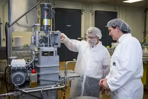 Man and woman looking at a machine.