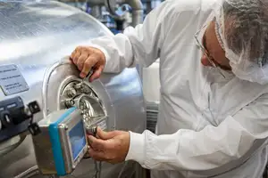 Man looking into a machine.